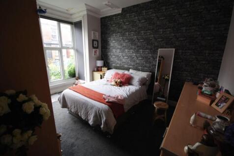 A spacious and well-maintained bedroom featurin...