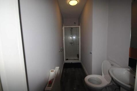A clean and modern bathroom with a toilet, sink...