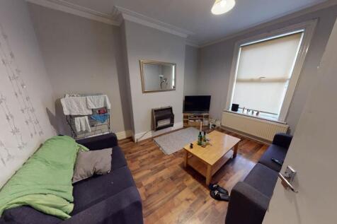 A bright and welcoming living room with ample n...