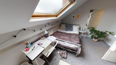 A cozy bedroom featuring a comfortable double b...