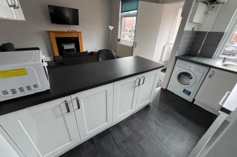 A bright, modern kitchen with ample workspace, ...