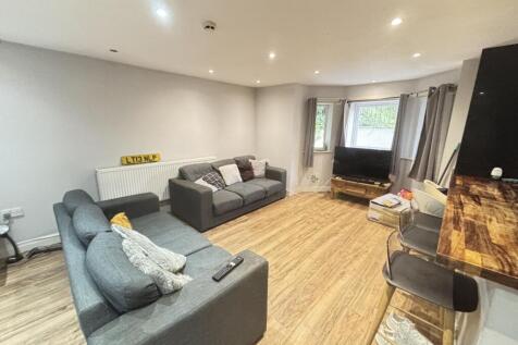 A spacious and well-lit contemporary living roo...