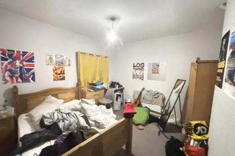 A cozy bedroom with a double bed, showing a com...