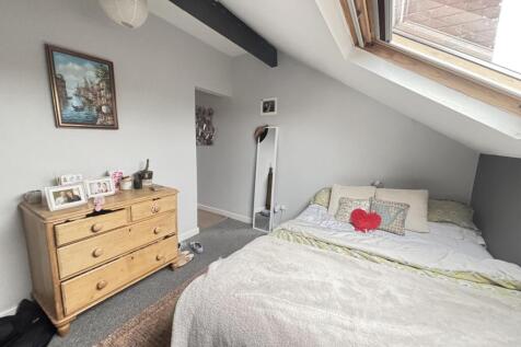 A bright and inviting master bedroom featuring ...