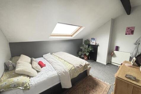 Bright and spacious master bedroom featuring a ...