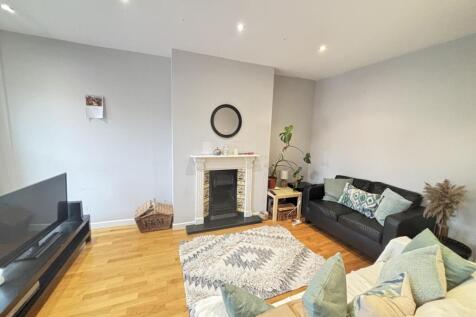 Bright and modern living room featuring ample n...