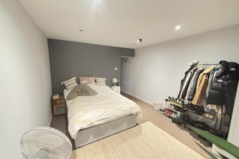 A bright, inviting double bedroom featuring a c...