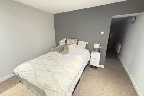 A bright and inviting double bedroom featuring ...