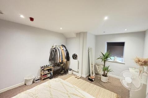 Bright and modern living room with ample natura...