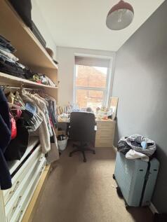 A cozy bedroom featuring a window that lets in ...