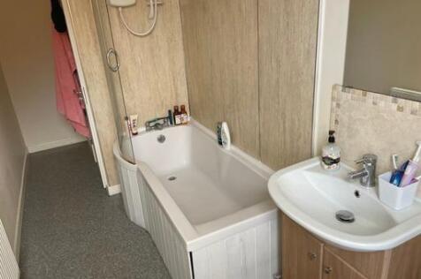 A clean and well-maintained bathroom with a bat...