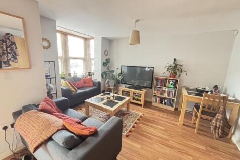 A bright, spacious living room with comfortable...