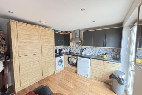 A modern kitchen featuring ample work surfaces,...