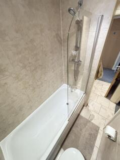 A modern bathroom suite featuring a spacious ba...