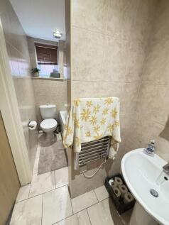 A tidy bathroom featuring a sink with a mirror,...
