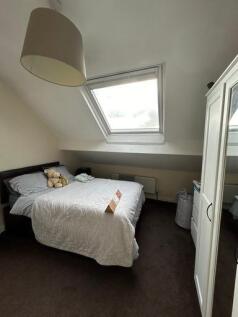 A cozy and well-maintained bedroom with a comfo...