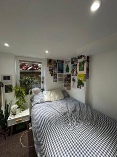 A cozy and well-decorated bedroom featuring a n...