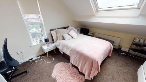 A cozy, well-maintained bedroom featuring a dou...