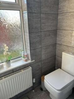 A modern bathroom featuring a clean toilet, a f...