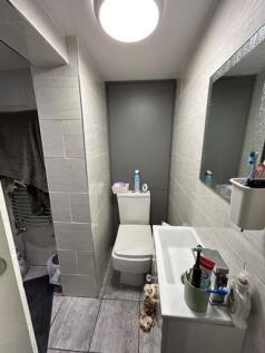 Bright and modern bathroom featuring a large ba...