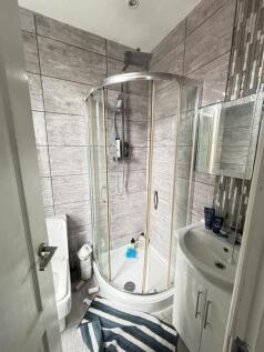 A clean and modern bathroom featuring a corner ...