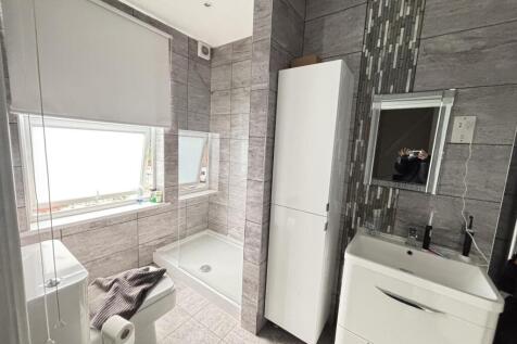 A clean and modern bathroom featuring a spaciou...