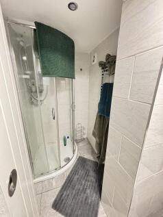 A modern bathroom featuring a shower enclosure ...