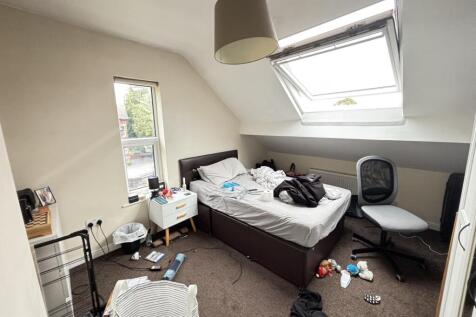 A spacious master bedroom with a large double b...