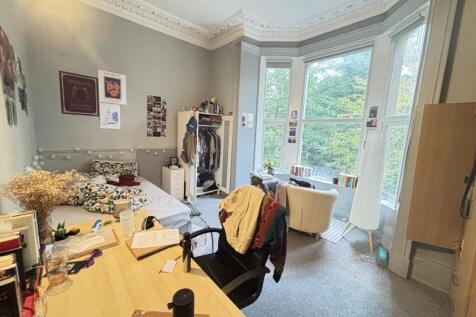 Bright and spacious living room with large wind...