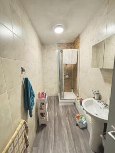 A clean and modern bathroom with a shower enclo...
