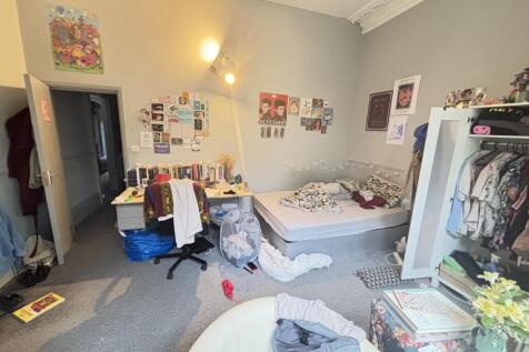 A cozy bedroom featuring a large bed and person...