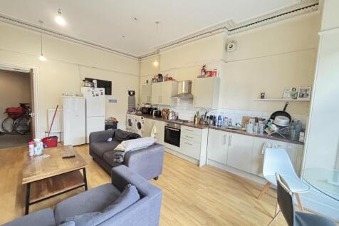 A bright and spacious living room featuring com...