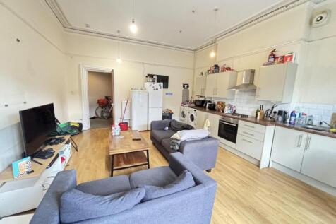 A spacious and well-lit contemporary living roo...