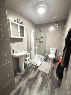 A modern and tidy bathroom with a shower enclos...