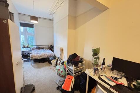 A cozy bedroom with a double bed and a small wo...