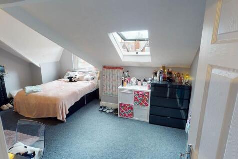 A cozy and well-maintained bedroom with a comfo...