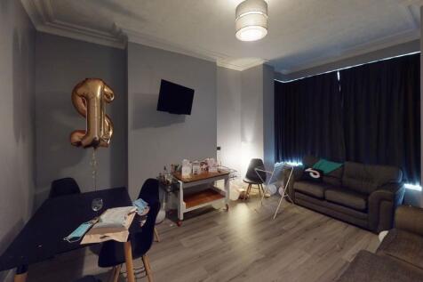 A spacious and well-lit living room featuring m...