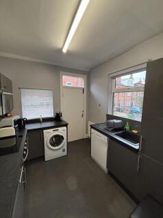 A modern kitchen space featuring ample natural ...