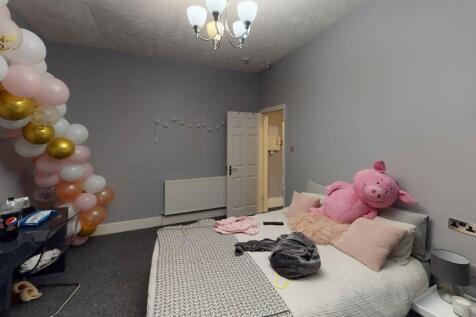 A cozy bedroom featuring a double bed with plus...