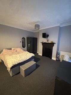 A spacious master bedroom featuring a large dou...