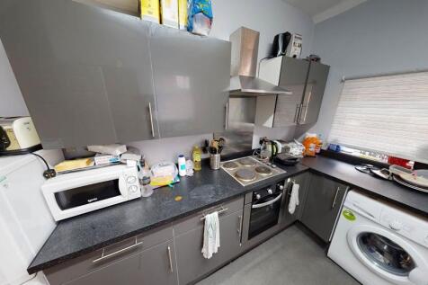 Modern kitchen space featuring appliances, coun...