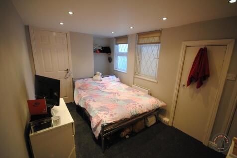 A bright and inviting double bedroom featuring ...