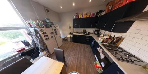 A modern and well-lit kitchen with ample counte...