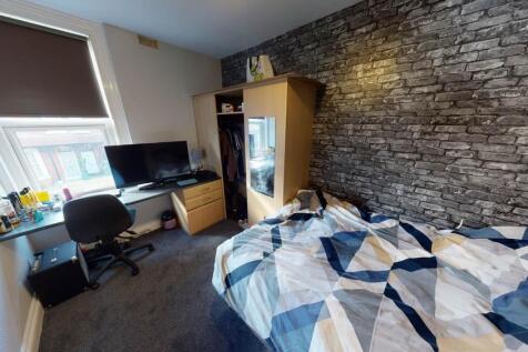 A cozy bedroom featuring a bed with a colorful ...