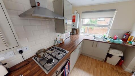 A modern, well-lit kitchen with ample counterto...