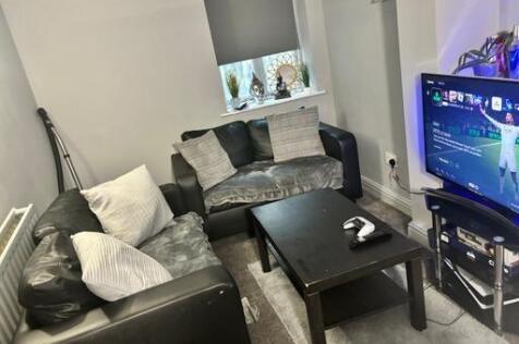 A cozy and well-lit living room featuring moder...