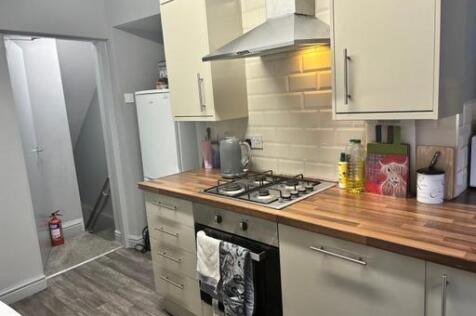 A well-maintained kitchen with modern cabinets,...