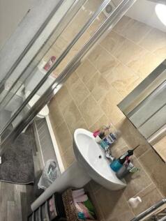 A clean and tidy bathroom featuring a white sin...