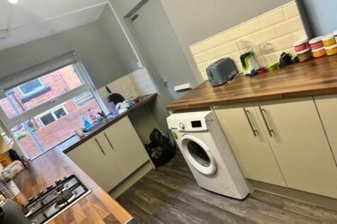 Modern and well-lit kitchen featuring ample cou...