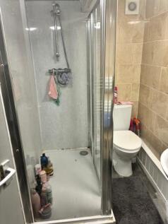 A functional bathroom featuring a shower cubicl...